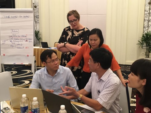 An expert from the University of Sunshine Coast and participants in a group discussion