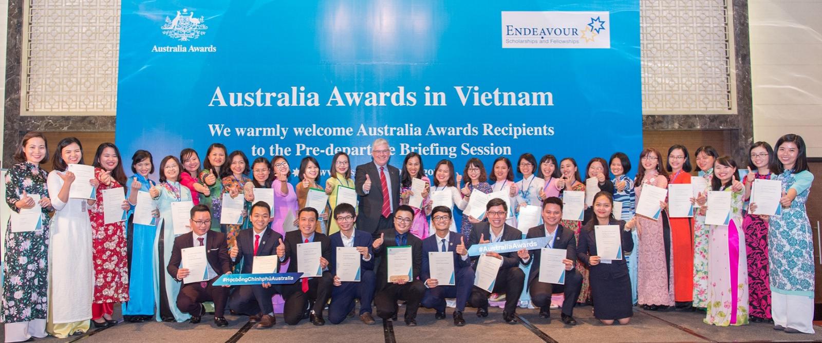 Australia Awards Scholarship recipients in a group photo with Ambassador Craig Chittick in Hanoi